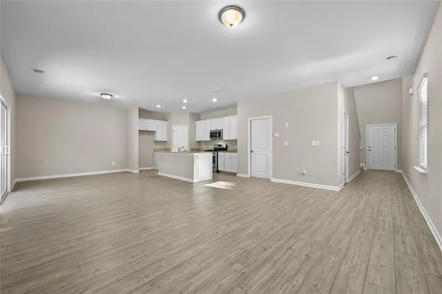 a view of a kitchen with a sink and wooden floor