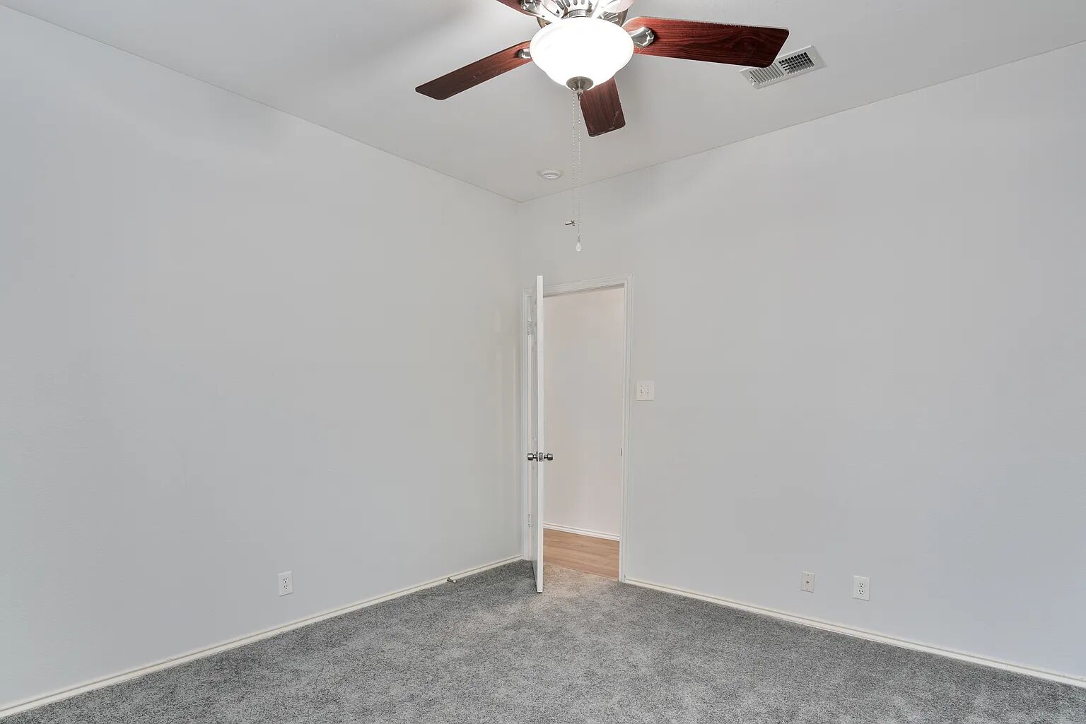 11970 Jollyville Road, Unit 202 Austin, TX 78759 - Photo 17 of 25 A comfortable bedroom features carpet flooring and a ceiling fan for year-round comfort.