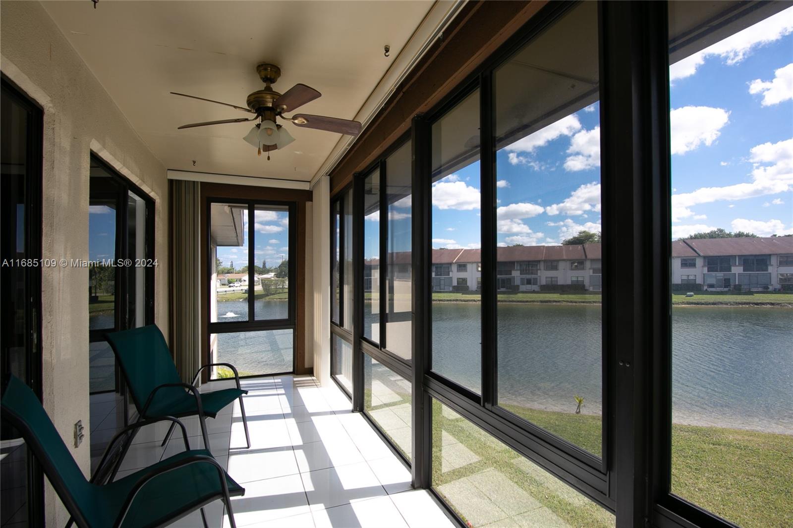 9626 West McNab Road, Unit 206 Tamarac, FL 33321 - Photo 12 of 21 a living room with hardwood floor and a floor to ceiling window