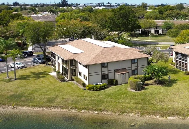 an aerial view of a house with swimming pool patio and lake view