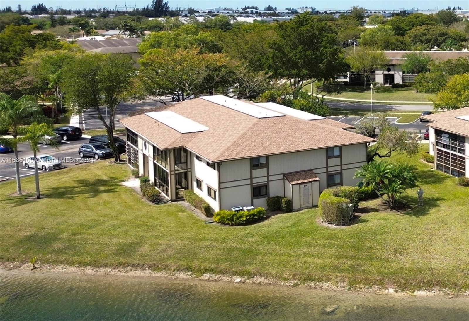 9626 West McNab Road, Unit 206 Tamarac, FL 33321 - Photo 17 of 21 an aerial view of a house with swimming pool patio and lake view