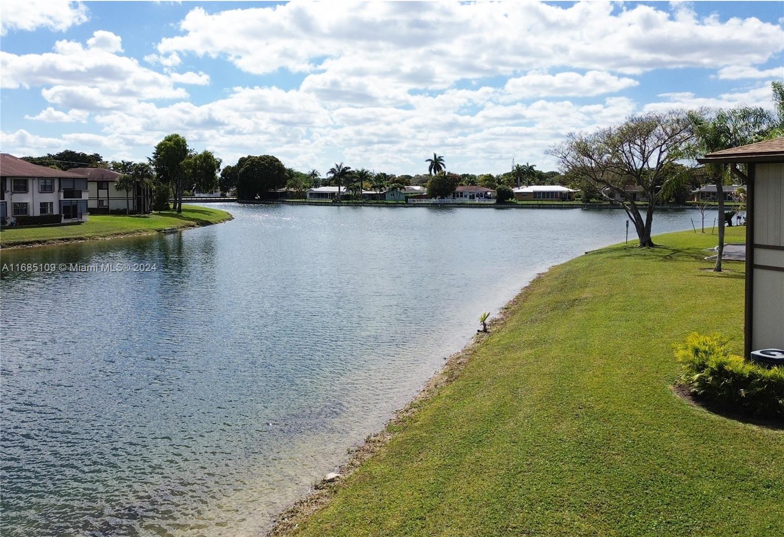 9626 West McNab Road, Unit 206 Tamarac, FL 33321 - Photo 20 of 21 a view of a lake with houses in the back