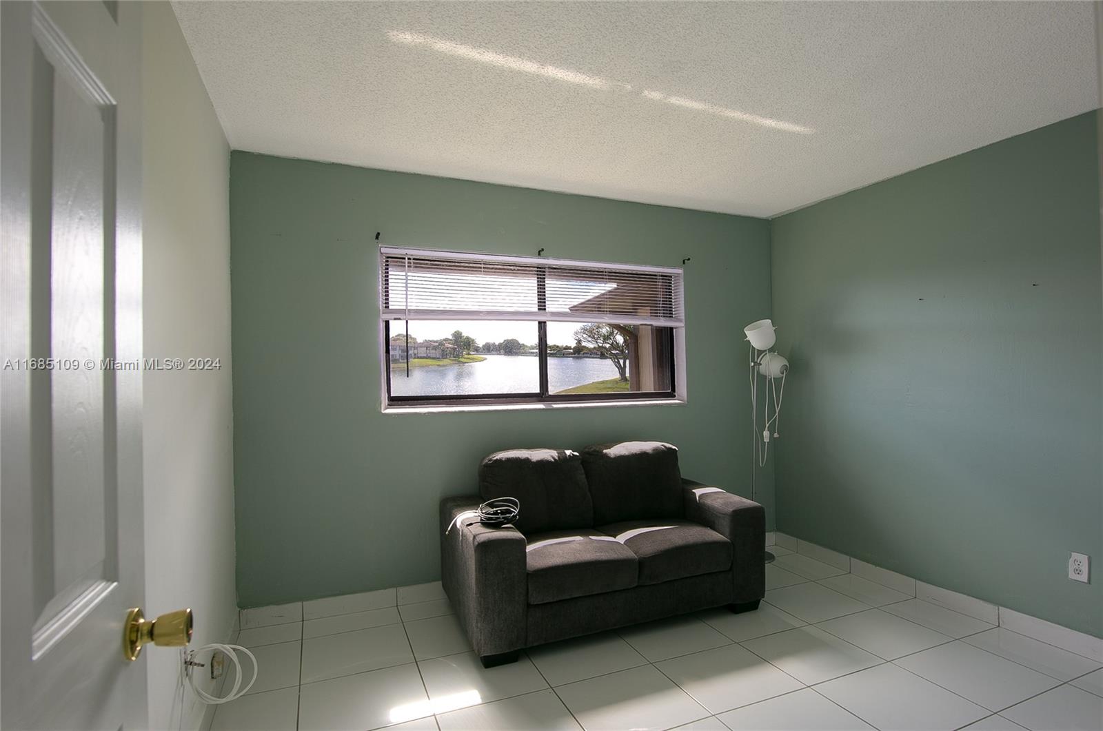 9626 West McNab Road, Unit 206 Tamarac, FL 33321 - Photo 7 of 21 a living room with furniture and a window