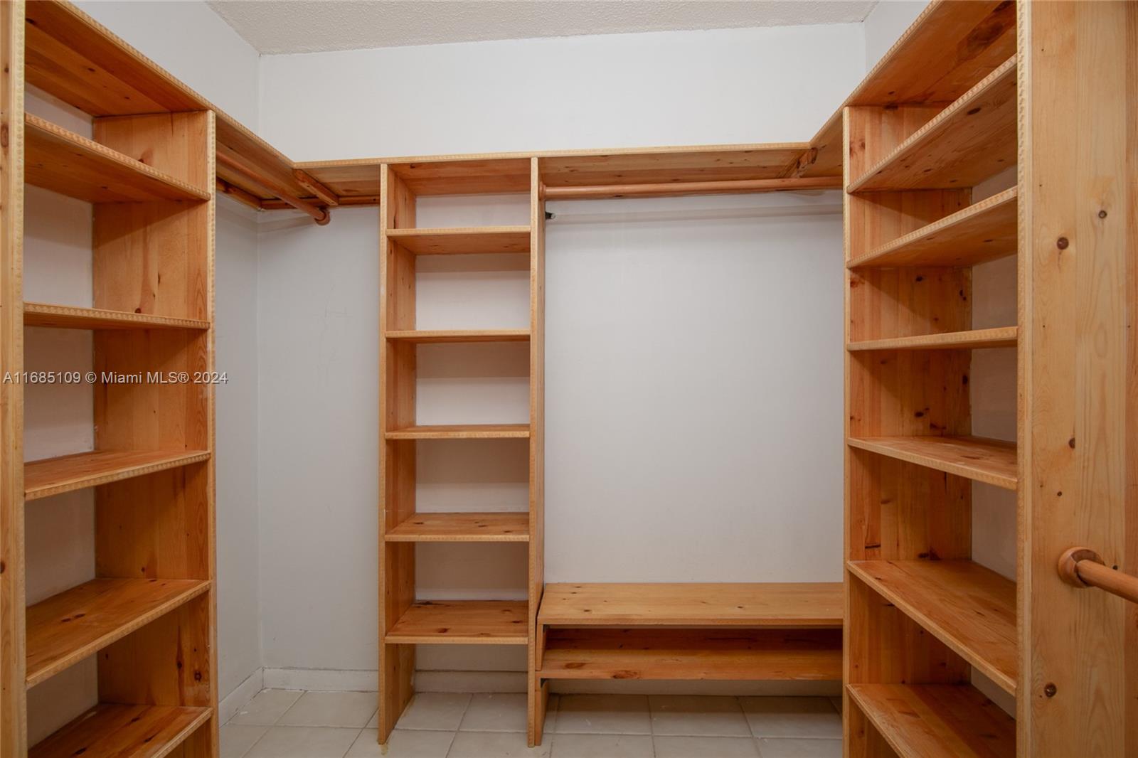 9626 West McNab Road, Unit 206 Tamarac, FL 33321 - Photo 8 of 21 a view of walk in closet with empty racks