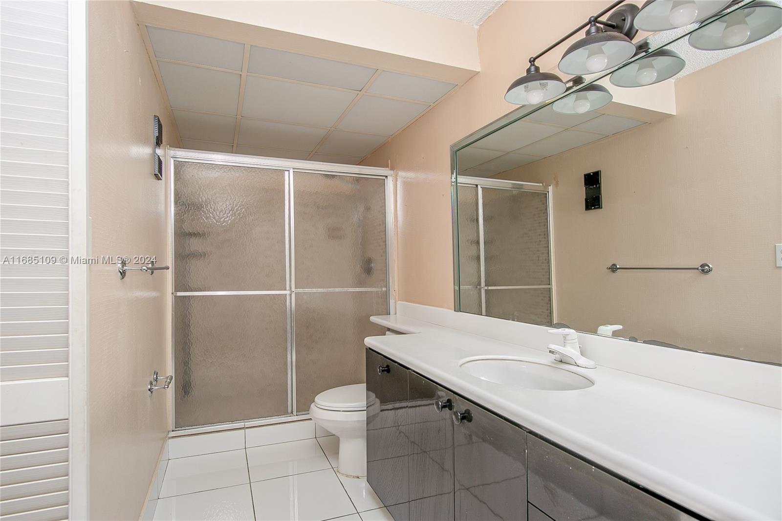 9626 West McNab Road, Unit 206 Tamarac, FL 33321 - Photo 9 of 21 a bathroom with a sink toilet and shower