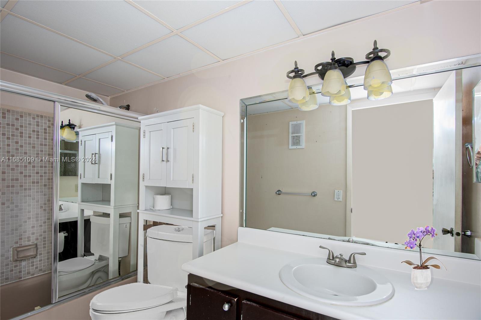 9626 West McNab Road, Unit 206 Tamarac, FL 33321 - Photo 10 of 21 a bathroom with a sink toilet and shower