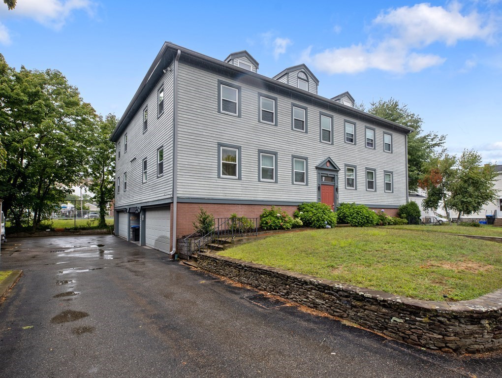 15 Church Street, Unit 8 Natick, MA 01760 - Photo 13 of 14 a front view of a house with garden