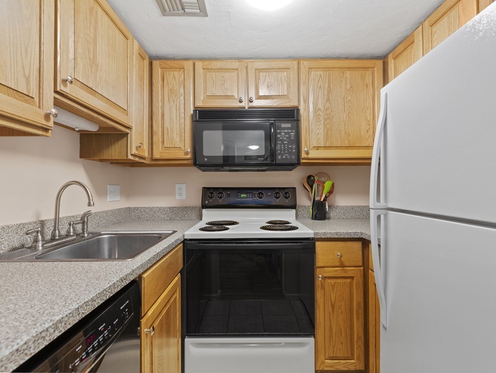 15 Church Street, Unit 8 Natick, MA 01760 - Photo 6 of 14 a kitchen with a sink a stove and refrigerator