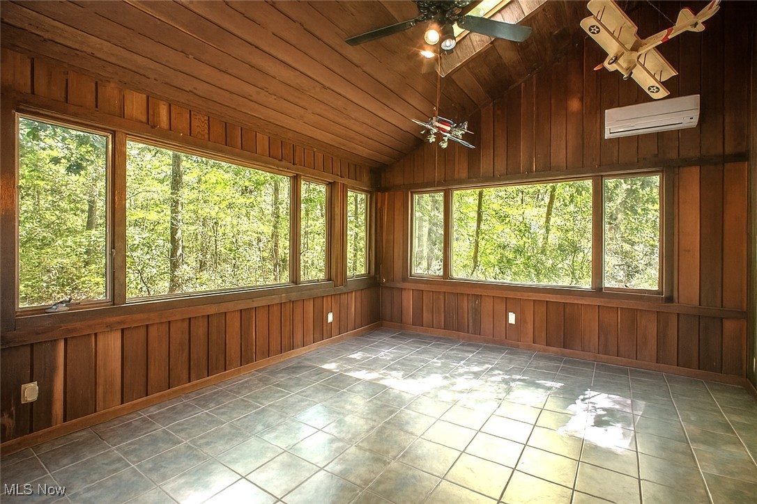 3085 Hamlin Road Medina, OH 44256 - Photo 16 of 50 Sunroom featuring lofted ceiling and a wall mounted split unit for heat and a/c