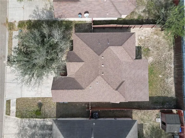 an aerial view of a house with a yard