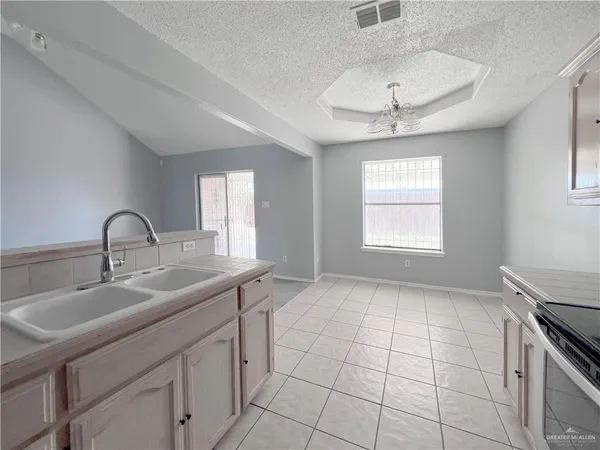 a kitchen with a sink cabinets and window