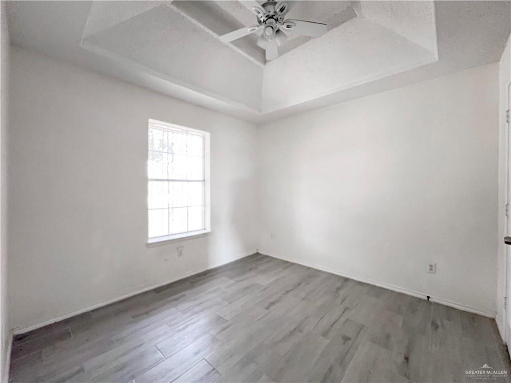 5716 North 38th Street McAllen, TX 78504 - Photo 15 of 28 an empty room with a window and a chandelier fan