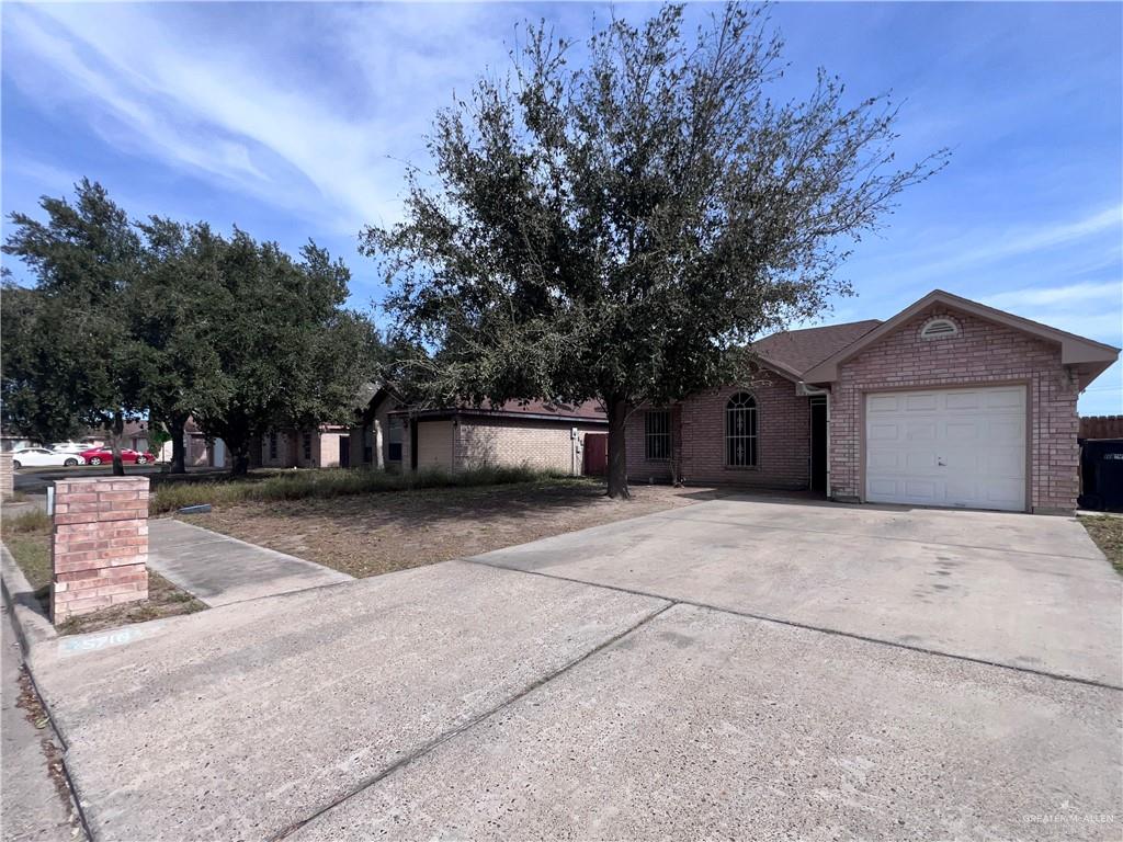 5716 North 38th Street McAllen, TX 78504 - Photo 2 of 28 a front view of a house with a yard and garage