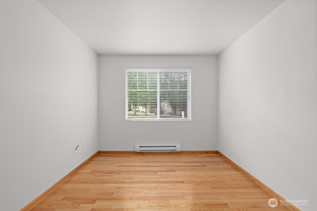 15325 Southeast 155th Place, Unit X1 Renton, WA 98058 - Photo 12 of 21 an empty room with wooden floor and windows