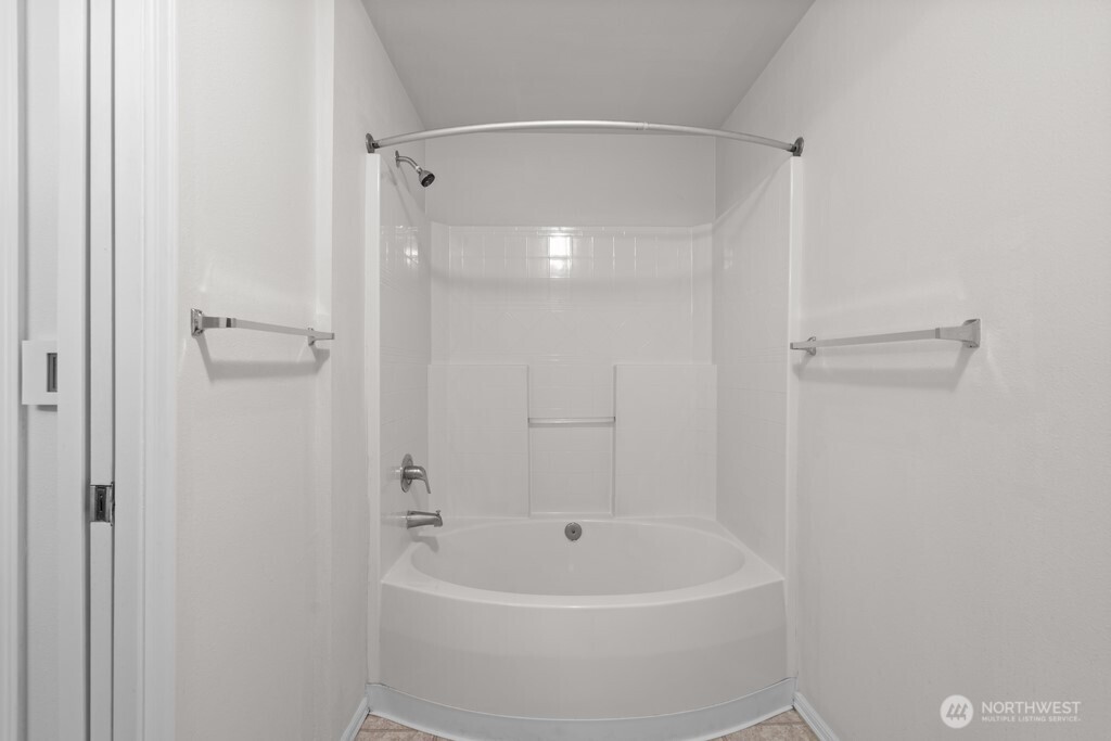 15325 Southeast 155th Place, Unit X1 Renton, WA 98058 - Photo 13 of 21 a white bath tub sitting next to a shower