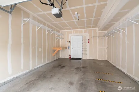 an empty room with a ceiling fan and stairs
