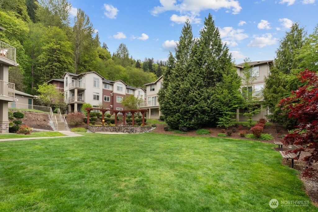 15325 Southeast 155th Place, Unit X1 Renton, WA 98058 - Photo 20 of 21 a view of a house with a big yard and large trees
