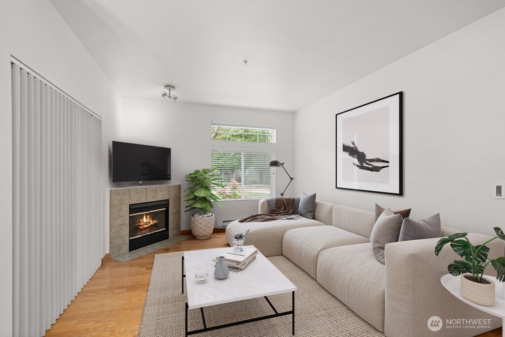 15325 Southeast 155th Place, Unit X1 Renton, WA 98058 - Photo 4 of 21 a living room with furniture a flat screen tv and a fireplace