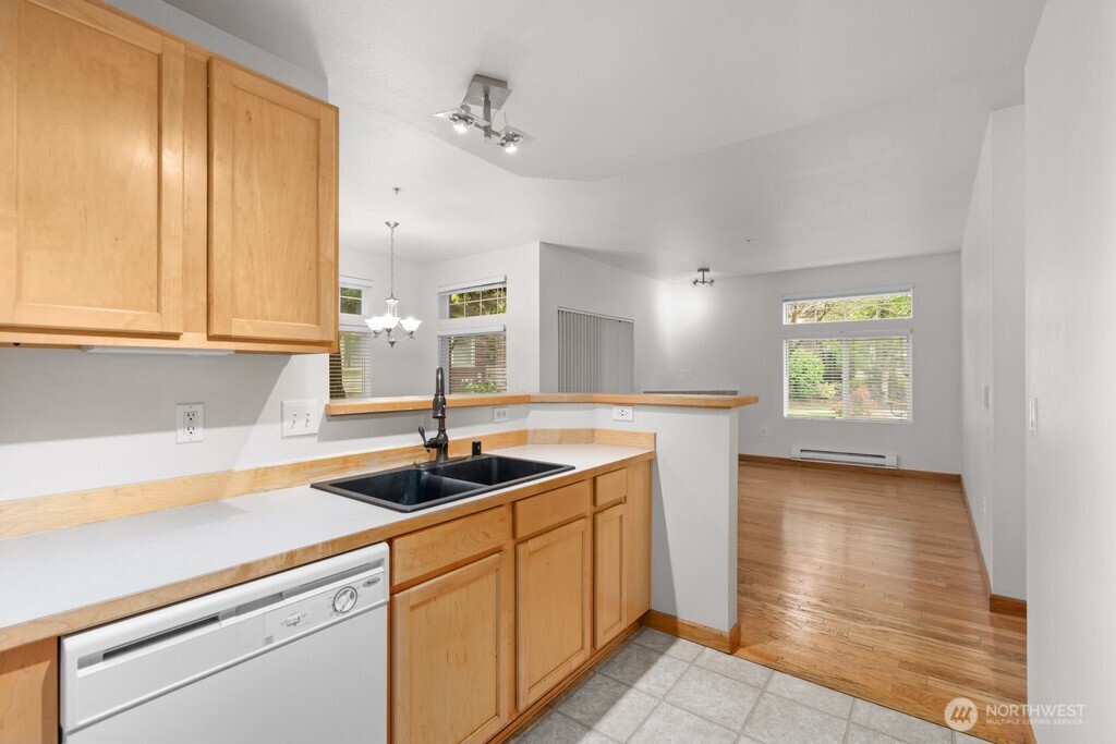 15325 Southeast 155th Place, Unit X1 Renton, WA 98058 - Photo 6 of 21 a kitchen with a sink and cabinets