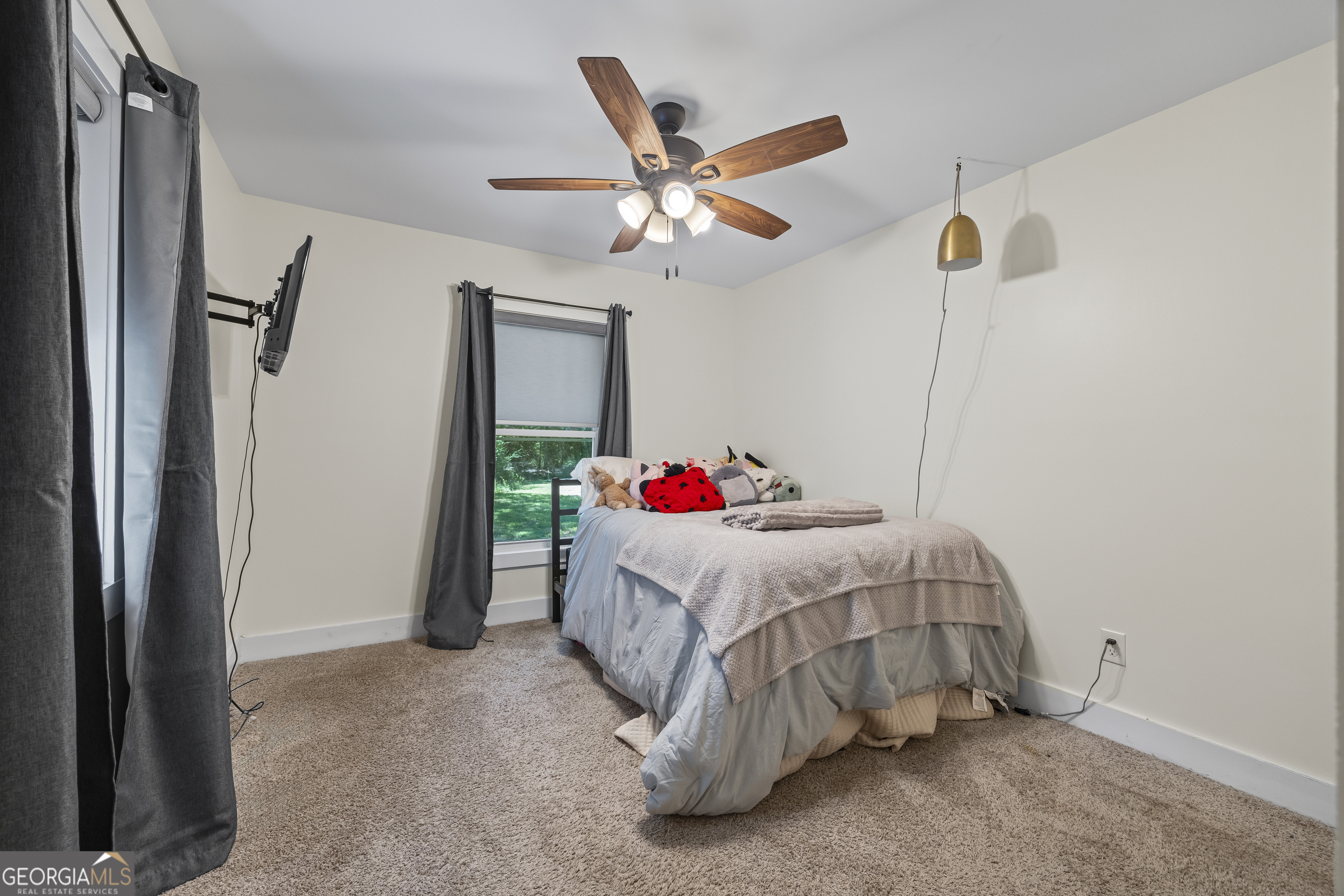 711 Shackelford Road Royston, GA 30662 - Photo 29 of 50 a bedroom with a bed and a chandelier