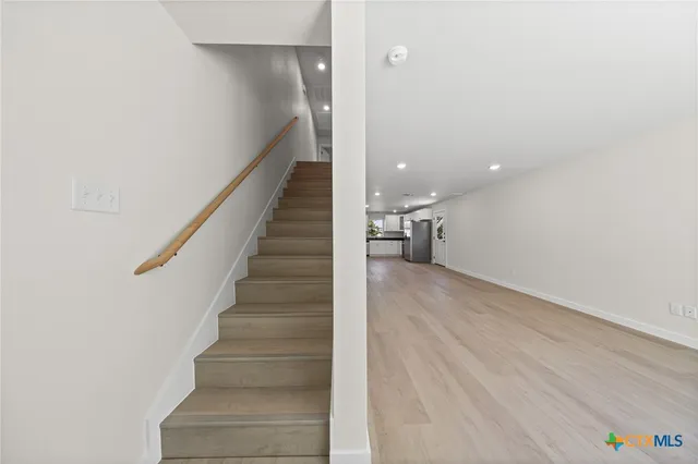a view of entryway and hall with wooden floor