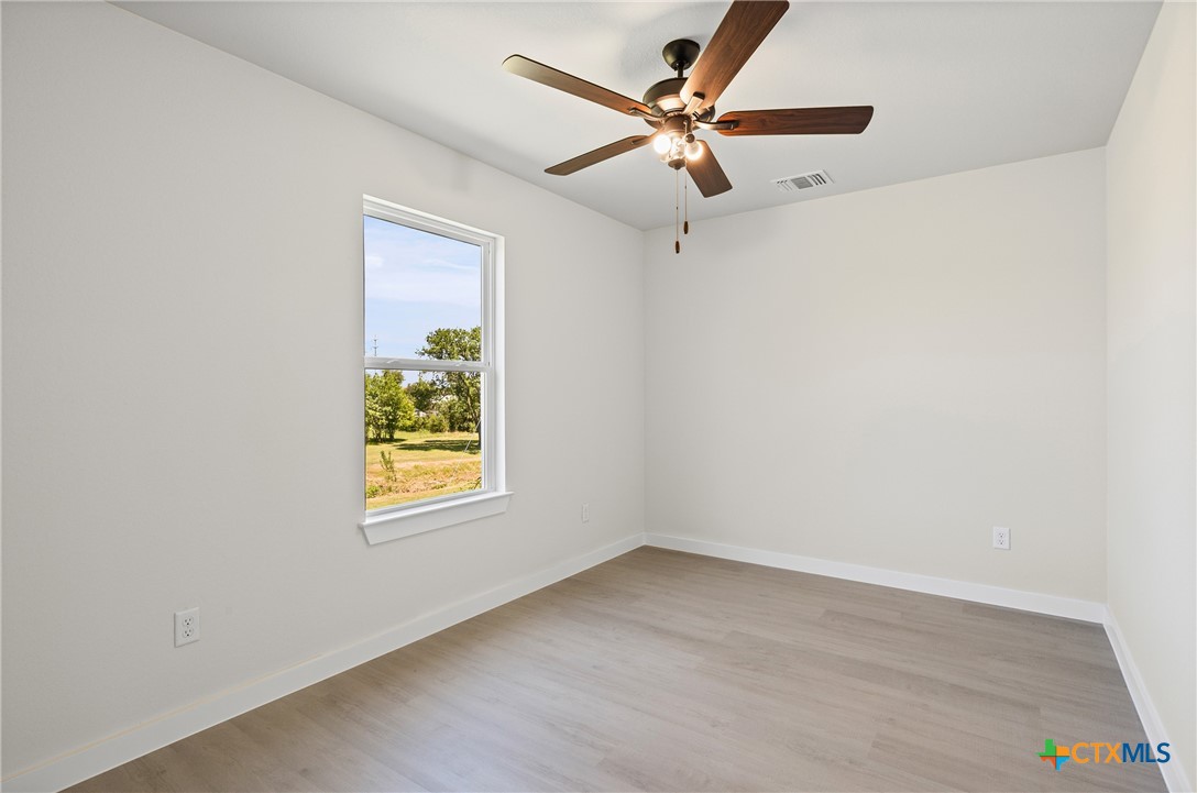 602 South 18th Street, Unit B Temple, TX 76501 - Photo 16 of 24 an empty room with a window and a ceiling fan