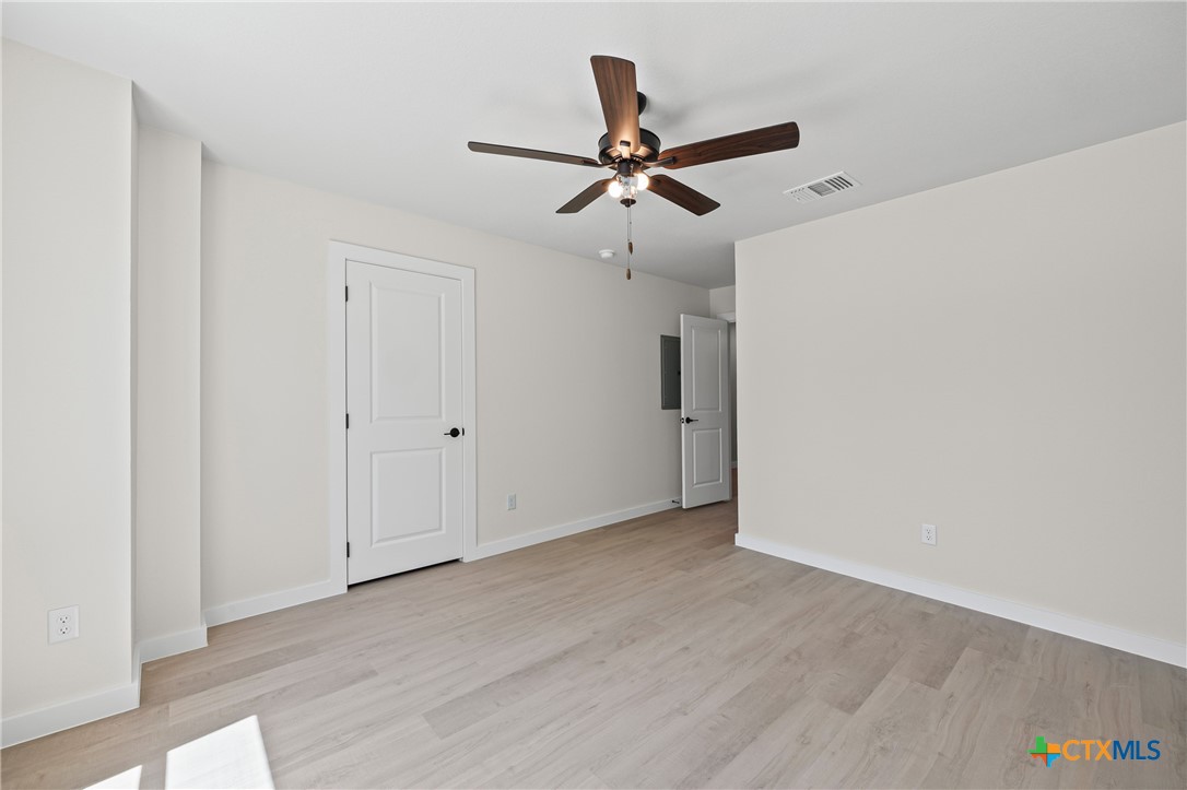 602 South 18th Street, Unit B Temple, TX 76501 - Photo 20 of 24 a view of a big room with wooden floor closet ceiling fan and windows