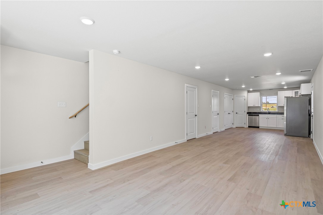 602 South 18th Street, Unit B Temple, TX 76501 - Photo 4 of 24 an empty room with wooden floor and appliances