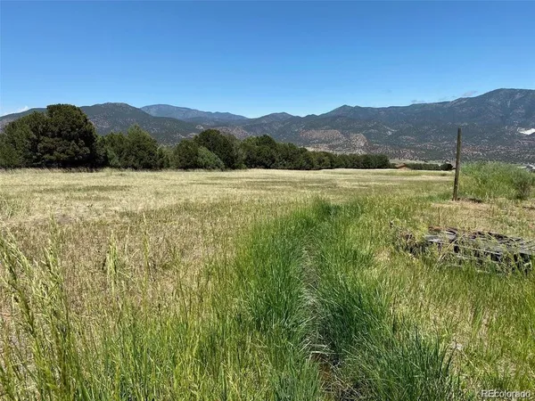 a view of a lush green hillside and a building