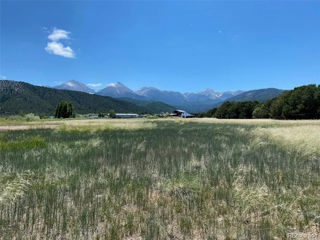 a view of mountain with sunset in background