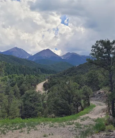 a view of city and mountain in a field