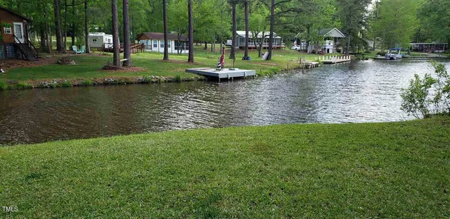 a view of a lake with houses and large trees