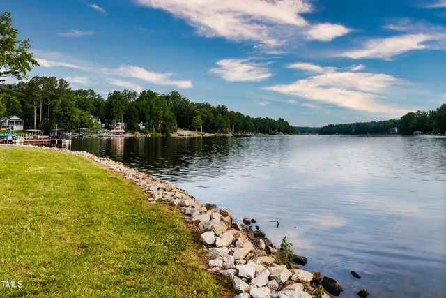 a view of a lake with houses in the back