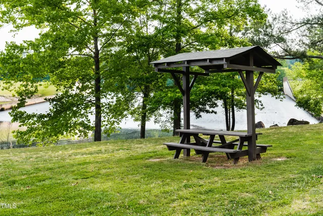 a view of a swimming pool with a patio and a garden