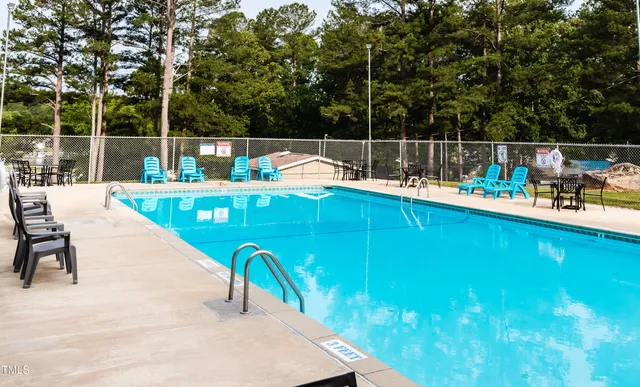 swimming pool view with a seating space