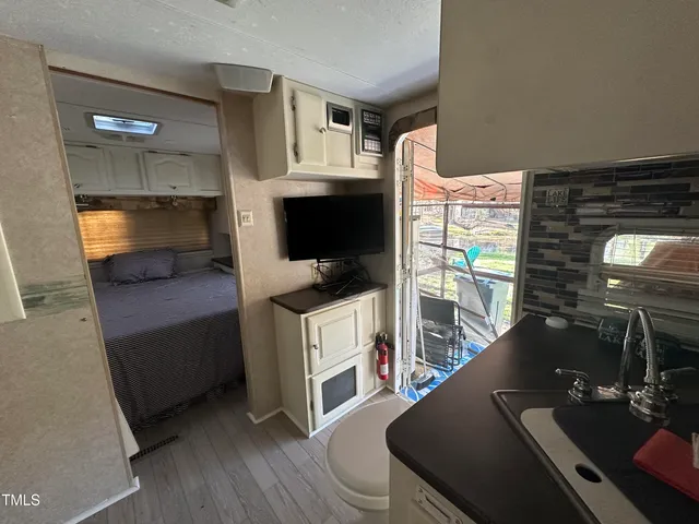 a kitchen view of microwave and furniture