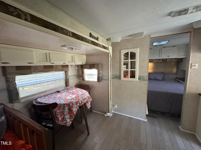 a bedroom with bed and wooden floor