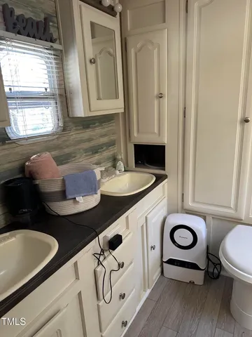 a bathroom with a sink a toilet and a mirror