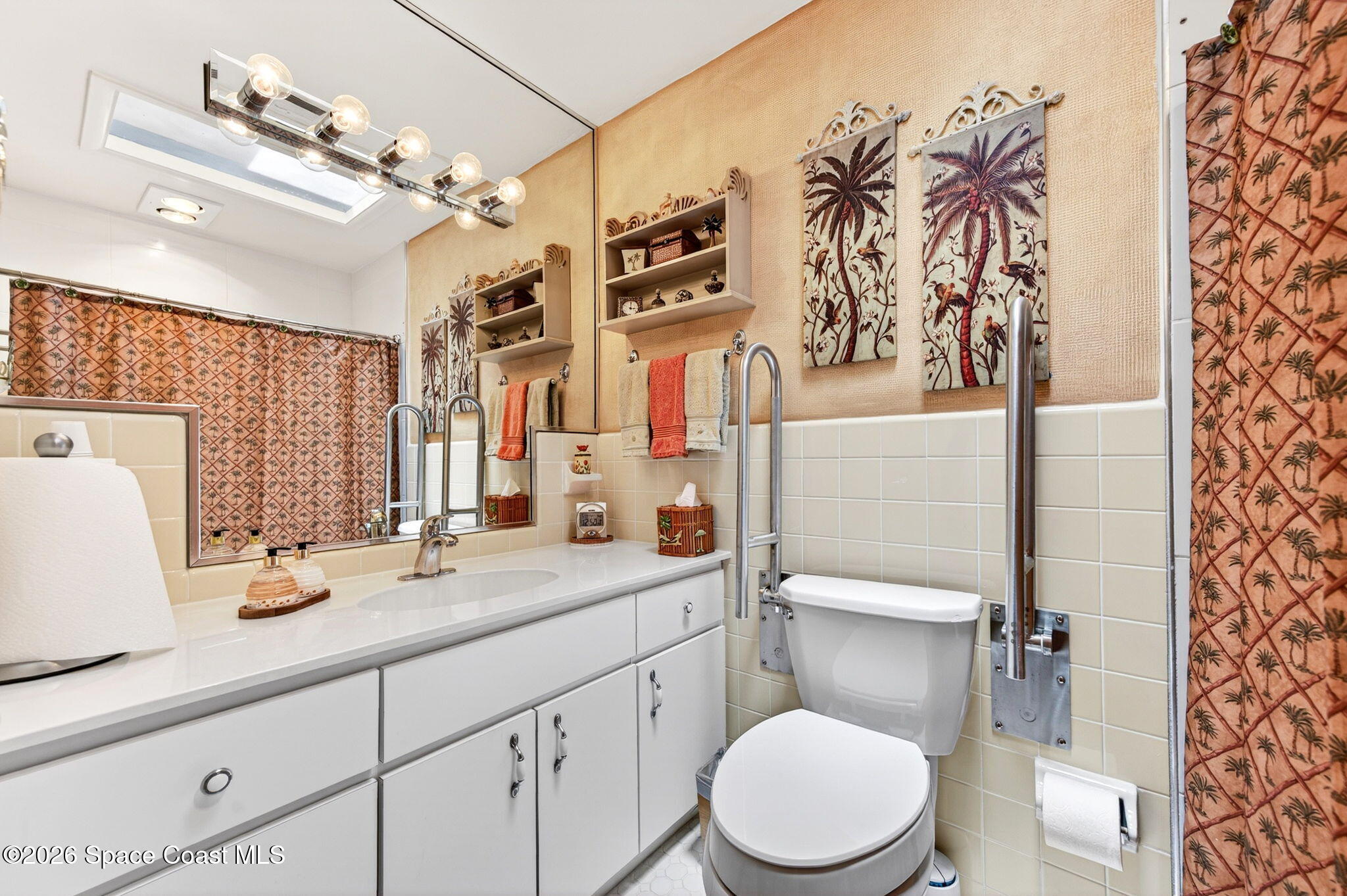 935 Samar Road Cocoa Beach, FL 32931 - Photo 15 of 22 a bathroom with a granite countertop toilet sink and mirror