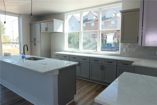 a kitchen with a sink stove and refrigerator