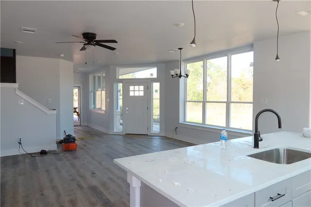 a kitchen with sink refrigerator and window