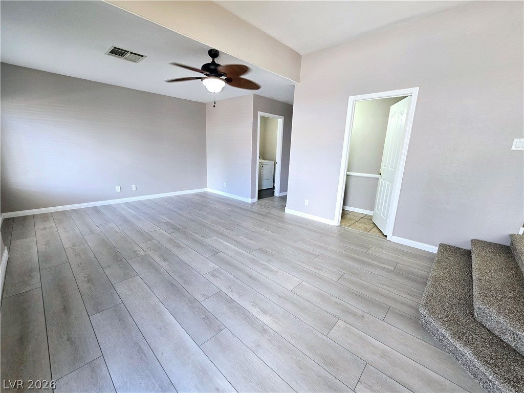 3759 Funston Way Las Vegas, NV 89129 - Photo 19 of 31 Natural light illuminates this spacious living area, featuring light hardwood-style flooring and an inviting ambiance.