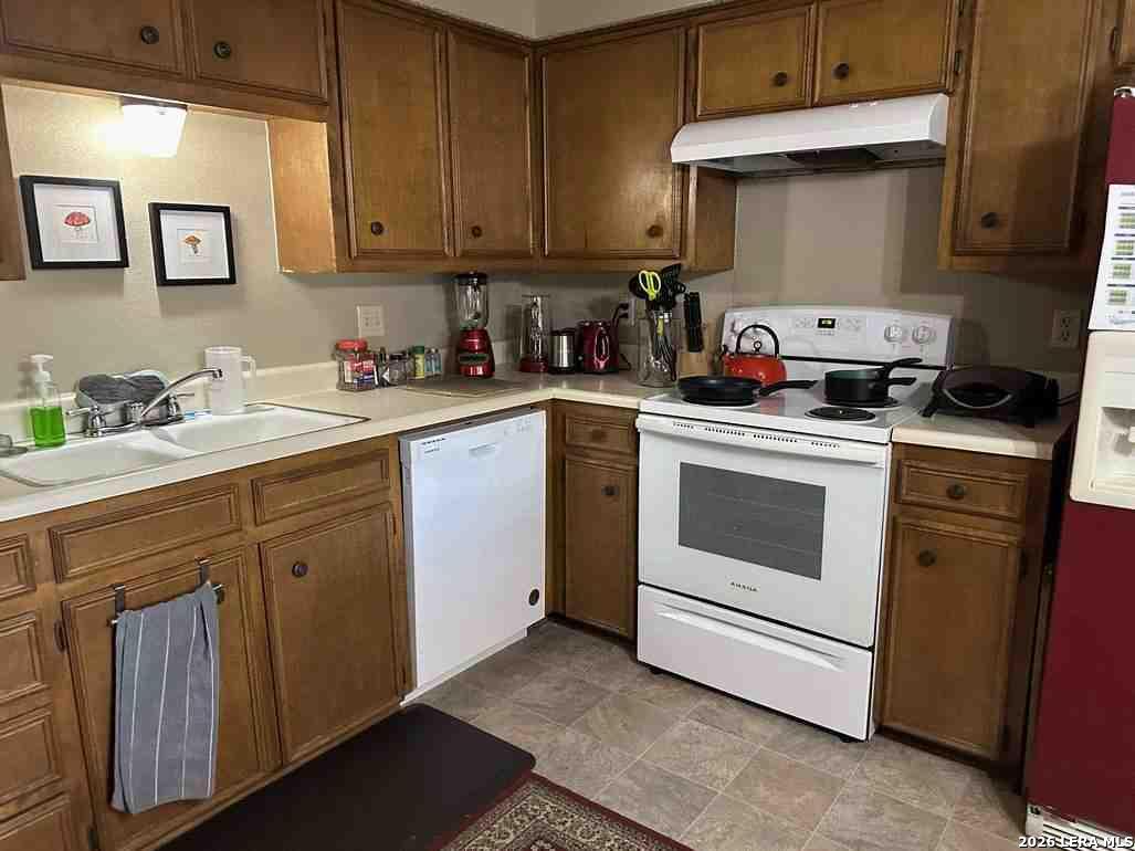 1533 Eichen Road New Braunfels, TX 78130 - Photo 13 of 24 a kitchen with cabinets appliances a sink and a counter top