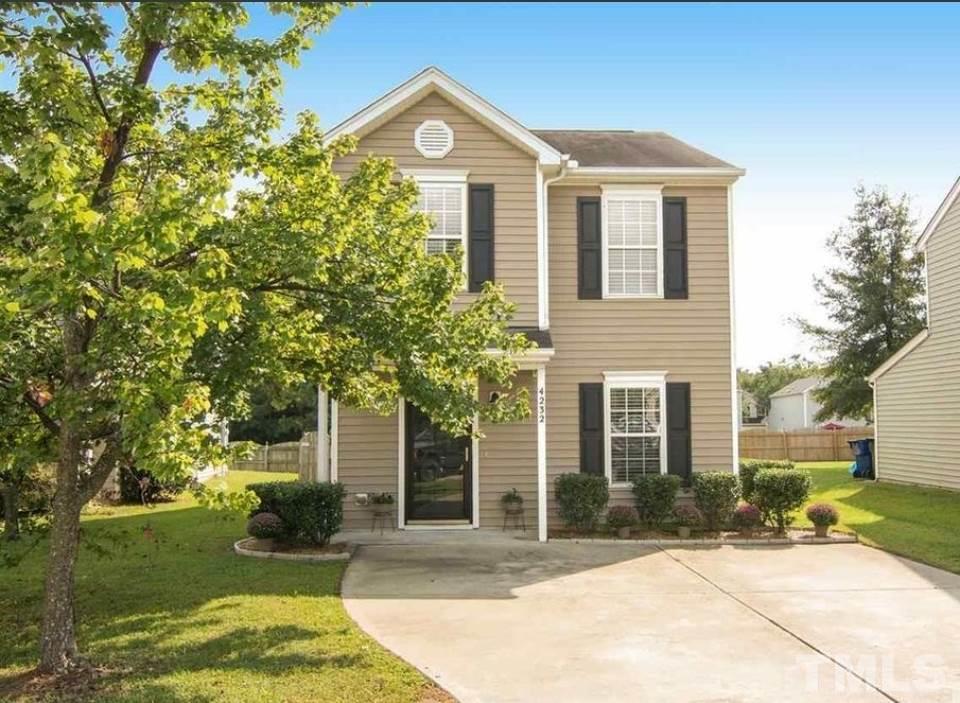 4232 Tensity Drive Raleigh, NC 27604 - Photo 1 of 13 a front view of a house with a yard and potted plants