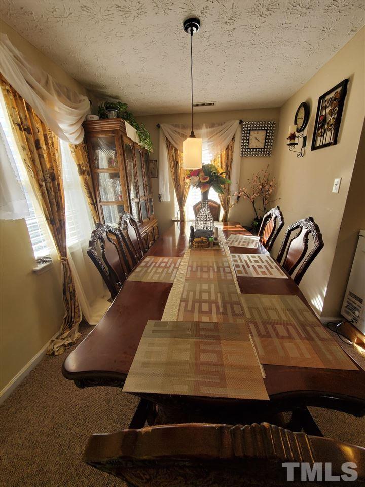 4232 Tensity Drive Raleigh, NC 27604 - Photo 5 of 13 a living room with furniture and a chandelier