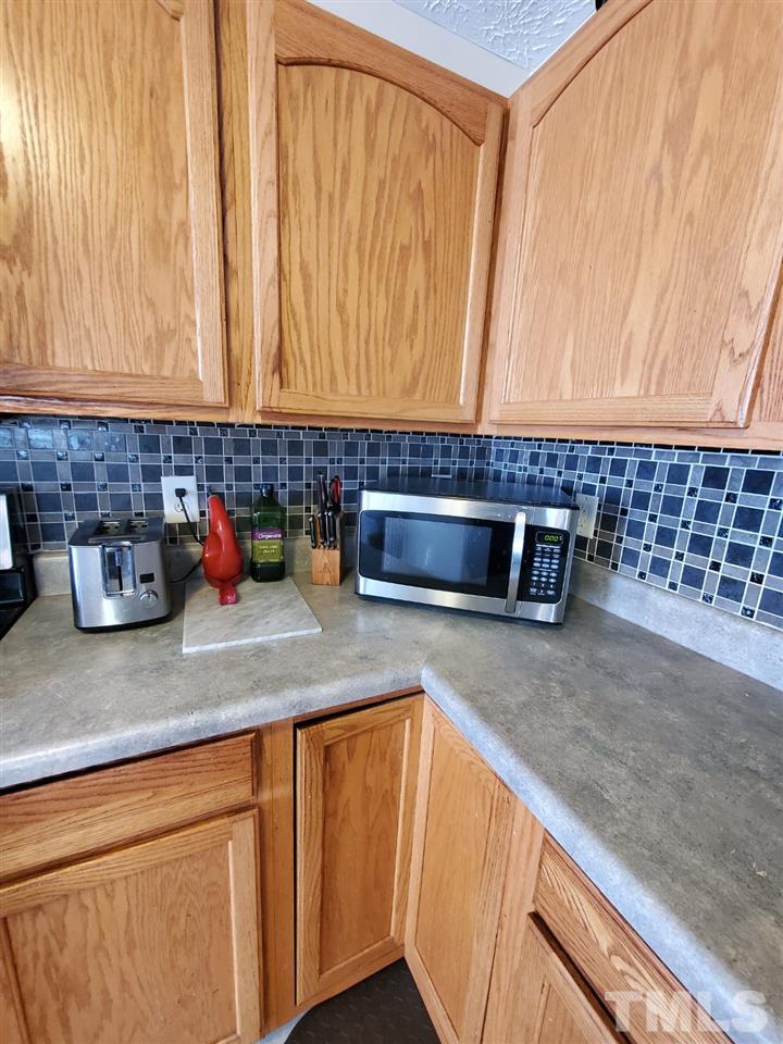 4232 Tensity Drive Raleigh, NC 27604 - Photo 7 of 13 a kitchen with stainless steel appliances granite countertop a sink and a cabinets