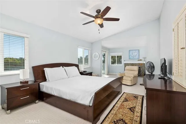 a bedroom with bed a couch and a chandelier