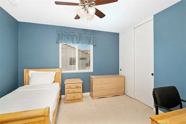 a bedroom with a bed and a chair