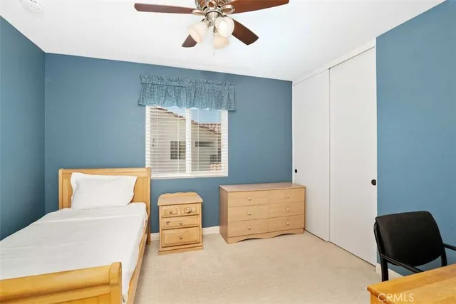 a bedroom with a bed and a chair