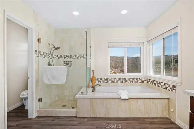 a view of bathroom with bathtub and shower